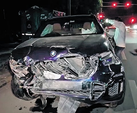 Wreckage of a BMW car lies on a road after an accident in New Delhi, Sunday, Sept. 14, 2025.