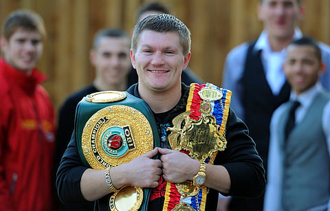 British boxer Ricky Hatton stands with his Ring Magazine Light Welterweight Champion Belt (R) and his IBO Light Welterweight world championship belt 