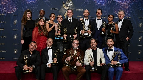 The team from "The Studio" pose in the press room with the award for outstanding comedy series during the 77th Primetime Emmy Awards on Sunday, Sept. 14, 2025, at the Peacock Theater in Los Angeles. 