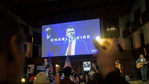 People hold candles and sing during a memorial and prayer vigil for Charlie Kirk at the John F. Kennedy Memorial Centre for the Performing Arts, Sunday, Sept. 14, 2025, in Washington.