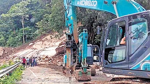 Debris from the landslide being removed from the NH stretch on Wednesday.