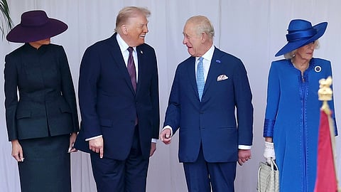 President Donald Trump and Britain's King Charles III, flanked by First lady Melania Trump, left, and Queen Camilla, share a light moment during the welcome ceremony at Windsor Castle in Windsor, England, Wednesday Sept. 17, 2025. 