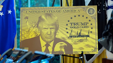 A poster showing the Trump Gold Card is pictured as President Donald Trump speaks in the Oval Office of the White House, Friday, Sept. 19, 2025, in Washington. 