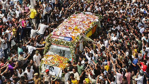 People gather as the mortal remains of singer Zubeen Garg being taken to his residence from the Guwahati airport, Sunday, Sept. 21, 2025.