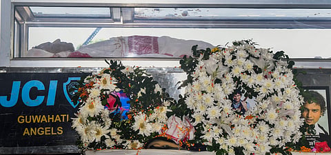 Mortal remains of Assam's cultural icon and singer Zubeen Garg are seen kept in a glass casket draped with a traditional Assamese gamosa, at Sarusajai stadium, in Guwahati, Monday, Sept. 22, 2025.