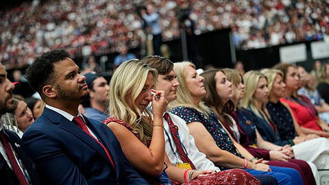 People listen as Erika Kirk speaks at a memorial for her late husband conservative activist Charlie Kirk, Sunday, Sept. 21, 2025, at State Farm Stadium in Glendale, Ariz. 