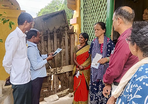 Officials interact with a family during the Socio-Economic and Educational Survey in Hubballi, Karnataka on Tuesday
