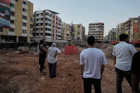 People gather at the site where Hezbollah leader Hassan Nasrallah was killed in Israeli airstrikes on Sept. 27, 2024, a few days before the first anniversary of his death, in Beirut, Lebanon, Monday, Sept. 22, 2025. 