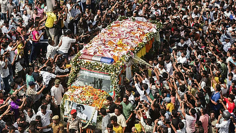 People gather as the mortal remains of singer Zubeen Garg being taken to his residence from the Guwahati airport.