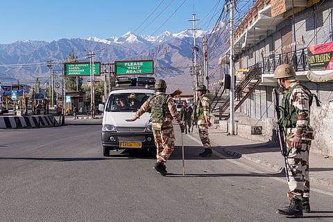 Security personnel stand guard during a curfew after recent protests for statehood turned violent, in Leh, Ladakh, Friday, Sept. 26, 2025.
