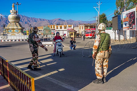 Security personnel stand guard during a curfew after recent protests for statehood turned violent leaving four people dead and 90 others injured, in Leh, Ladakh, Friday, Sept. 26, 2025. 