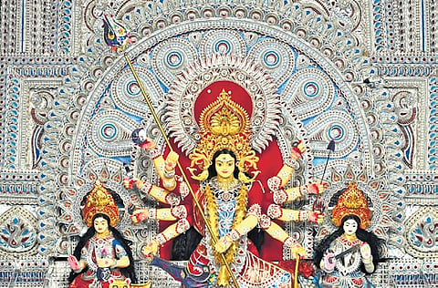 The idols of Goddess Durga, Lakshmi and Saraswati adorning the gold crowns at the pandal near Ganesh Mandap, at Jharpada in Bhubaneswar.