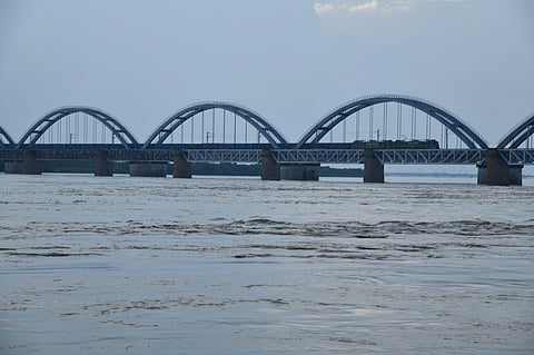 9.5 lakh cusecs flood water flowing in river Godavari due to low pressure areas. The flooded river with the third rail bridge in view at Rajamahendravaram. 