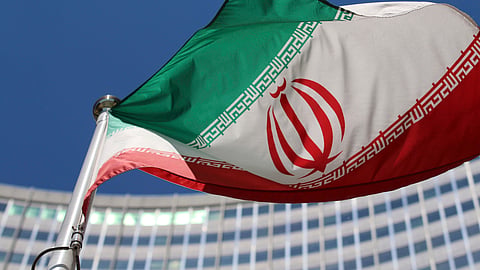 FILE - The Iranian flag flies in front of a U.N. building where closed-door nuclear talks take place at the International Center in Vienna, Austria, on June 18, 2014