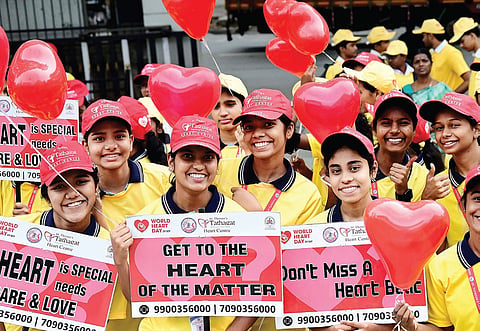 Staff of St Theresa’s Tathagat hospital and volunteers during a marathon to create awareness on heart health to mark the World Heart Day in Bengaluru on Monday.   