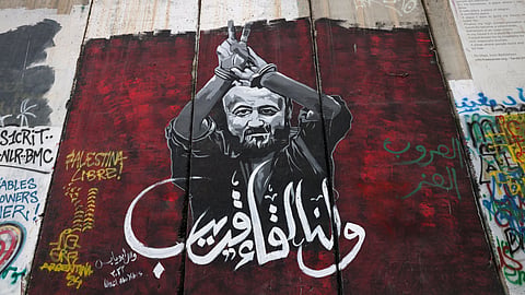 A picture shows a view of a mural depicting former high-ranking member of the Palestinian Fatah party and prominent detainee in Israeli custody Marwan Barghouti, on Israel's controversial separation barrier in Bethlehem town in the occupied West Bank on December 24, 2024. 