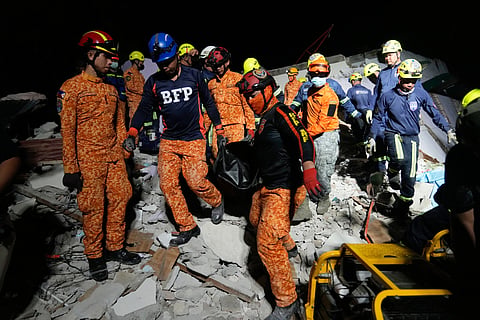 Rescuers bring down a body they recovered from the ruins of a collapsed building, Wednesday, Oct. 1, 2025 after a strong earthquake struck Bogo city, Cebu Province, Central Philippines.
