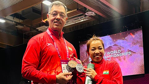 Mirabai Chanu celebrates her podium finish with head coach Vijay Sharma