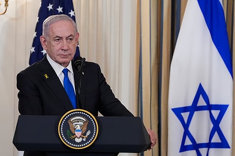 Israel's Prime Minister Benjamin Netanyahu listens as President Donald Trump speaks during a news conference in the State Dining Room of the White House, Monday, Sept. 29, 2025, in Washington. 