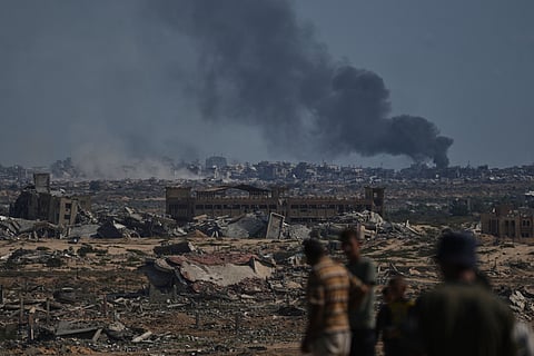 Smoke rises to the sky following an Israeli military strike in Gaza City, as seen from the central Gaza Strip, Thursday, Oct. 2, 2025.