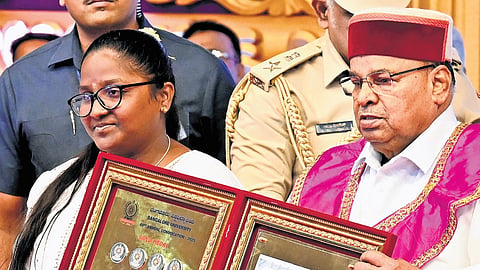 Prema S receives 11 gold medals in MA Kannada from Governor Thaawarchand Gehlot at the Bangalore University Convocation on Wednesday 