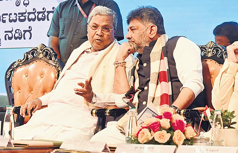 CM Siddaramaiah in conversation with Deputy CM DK Shivakumar at a programme to launch ‘Neeriddre Nale’ initiative in Bengaluru on Thursday. 