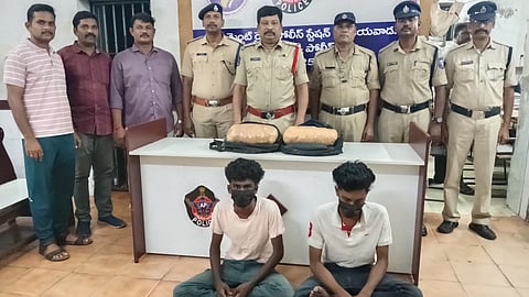 Government railway police with the two arrested men (natives of Tamil Nadu) on Thursday. 