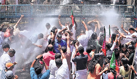 Police using water cannons to disperse BJP workers who took out a protest march to the office of Devaswom Minister V N Vasavan in Ettumanoor on Saturday 