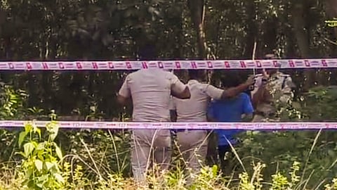 West Bengal Police personnel during reconstruction of the crime scene as part of the ongoing probe into the medical student rape case, in Durgapur, West Bengal, Tuesday, Oct. 14, 2025.