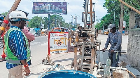 Agency workers collect soil samples for geotechnical investigation  at the site of the proposed elevated corridor