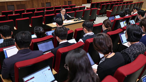 South Korea's National Security Advisor Wi Sung-lac (C, top) speaks during a press conference at the Presidential Office in Seoul on October 15, 2025.
