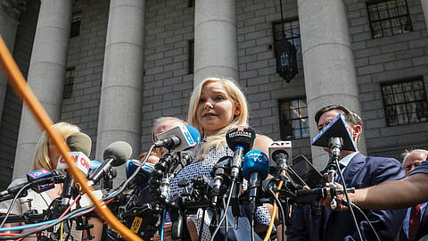 Virginia Roberts Giuffre, center, who says she was trafficked by sex offender Jeffrey Epstein, holds a news conference outside a Manhattan court where sexual assault claimants invited by a judge addressed a hearing following Epstein's jailhouse death in New York, Aug. 27, 2019.