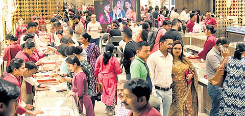 People buy gold from a jewellery store in Bhubaneswar on Dhanteras 
