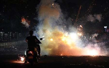 People burst firecrackers during the Diwali festival celebrations, in New Delhi o