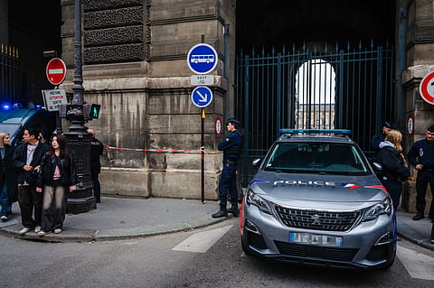 French police officers stand in front of the Louvre Museum after a robbery, in Paris on October 19, 2025.