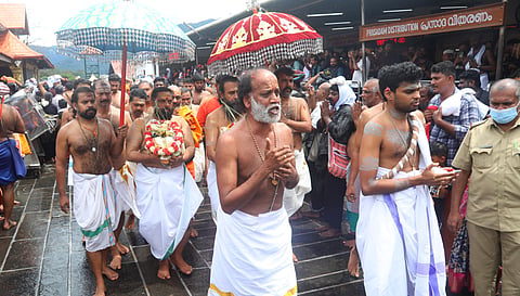 Thantri Kandararu Mahesh Mohanaru leading the procession carrying the brahmakalasam as part of the kalabhabhishekam ritual at Sabarimala on Sunday.