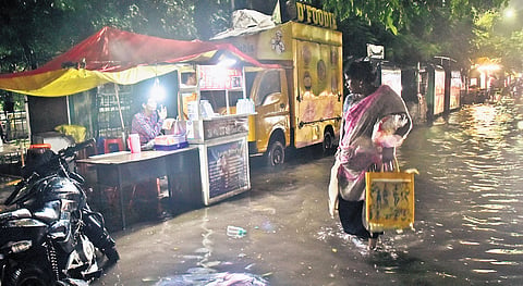Rainwater stagnated at Shenoy Nagar on Tuesday evening following incessant rain in the city; (Below) Deputy Chief Minister Udhayanidhi Stalin inspecting the desilting of canals at Keelkattalai on Tuesday 