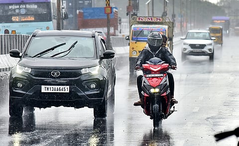Motorists drive through rain near Madhavaram as moderate rain experienced at some parts in Chennai. 