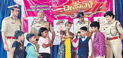 City Police Commissioner Seemant Kumar Singh and other top cops with children of police personnel: Right: Singh lights a sparkler 