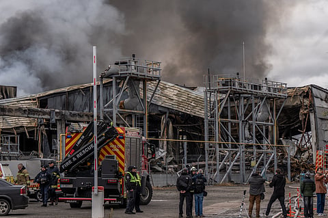Smoke bellows from a warehouse that caught fire following a Russian attack, Saturday, Oct. 25, 2025, in Kyiv, Ukraine. 