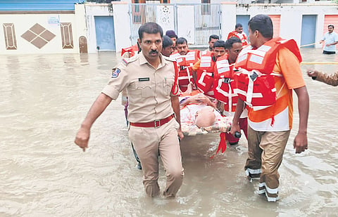Police and disaster response personnel carry out rescue operations in the 
low-lying colonies of flooded Warangal on Thursday.