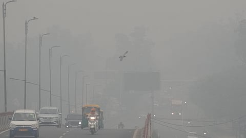 People commute as a layer of smog engulfs the city after deterioration in air quality in Delhi-NCR, in New Delhi, Thursday, Oct. 30, 2025.