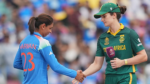 India's captain Harmanpreet Kaur,left, shakes hand with South Africa's captain Laura Wolvaardt