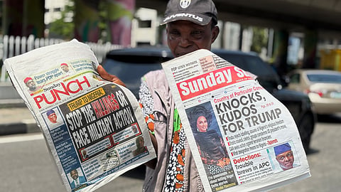 A vendor sells local newspapers with headlines referring to US President Donald Trump's comments about Nigeria, on the street of Lagos, Nigeria, Sunday, Nov. 2, 2025. 