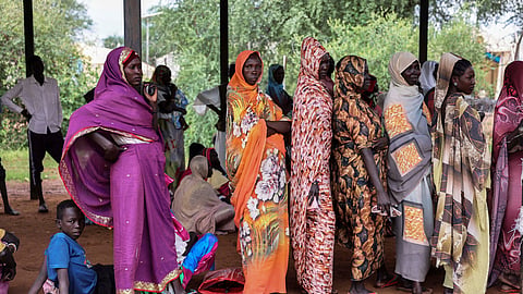 Women wait for cash assistance and dry grain from the UN World Food Program in Gendrassa refugee camp, Maban, South Sudan, on Aug. 20, 2025.
