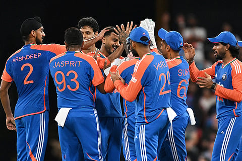 Axar Patel, centre, is congratulated by teammates after dismissing Australian batsman Matt Short during a T20 cricket international between India and Australia in Carrara, Australia, Thursday, Nov. 6, 2025