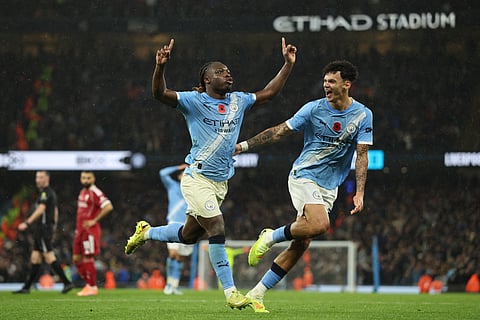 Manchester City's Jeremy Doku (L) celebrates with Nico O'Reilly after scoring their third goal during the EPL football match between Manchester City and Liverpool on November 9, 2025.