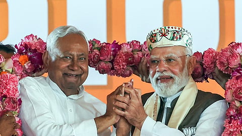 JD(U) chief and Bihar Chief Minister Nitish Kumar with Prime Minister Narendra Modi at a poll rally in Bihar.
