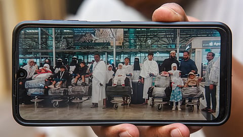 A man displays a photo of Syed Naseeruddin and his family while departing for Saudi Arabia, during police investigations, in Hyderabad, Monday, Nov. 17, 2025. Naseeruddin and 18 family members lost their lives in a bus fire accident in Saudi Arabia. 