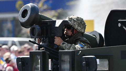 A Ukrainian serviseman rides atop of an APC with Javelin anti-tank missiles during a military parade in Kiev on August 24, 2018